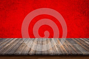 Empty top of wood table on red concrete wall background.