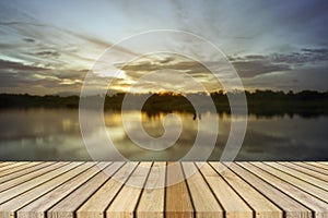 Empty top wooden decking and sunset moment at little lake background. Can use for product display