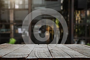 Empty top of wooden shelves on coffee shop ,tree front view background. For product display blur background image, for product