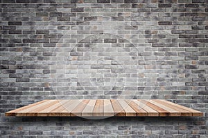 Empty top wooden shelves and stone wall background