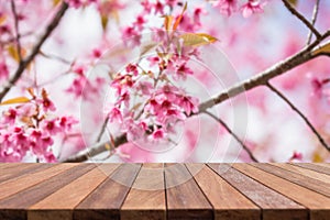 Empty top wooden table and flower field blurred background