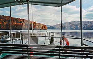 Empty tourist boat on beautiful lake in autumn photo