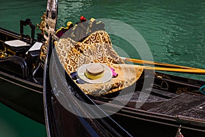 An empty traditional gondola with a gondolier`s hat on it, Venice, Italy