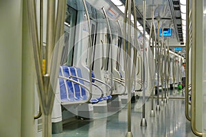 Empty train carriage with a modern interior and blue seats