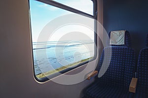 Empty train chair and sea view on the window