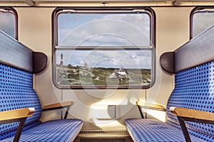 Empty train compartment with view on quaint landscape