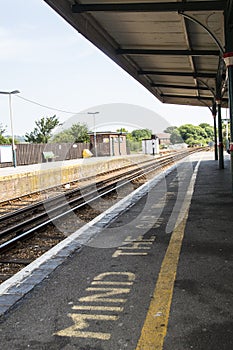 Empty train station platform - mind the gap warning