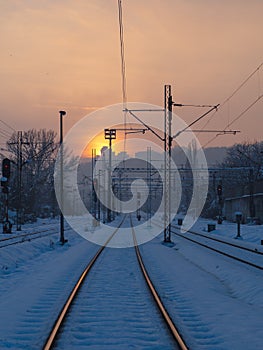 Empty train tracks at sunset - winter season