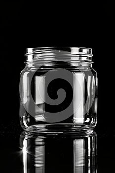 an empty transparent jar with black background