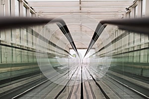 Empty travelator with glass handrails. Without people. Mechanized pedestrian crossing