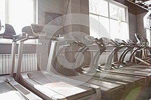 Empty treadmills in a row at sports studio
