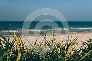 Empty tropical beach background, waves on the sea, blue sky