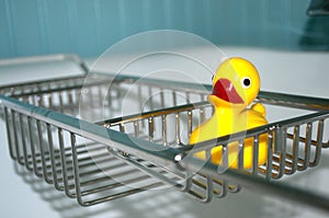 Empty tub with a yellow rubber duckie. photo