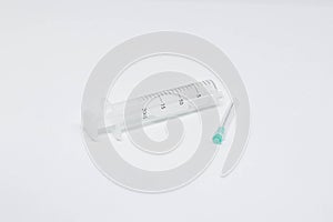 Empty twenty milliliter syringe and a needle  on white background. Medicine, treatments and healthcare. Medical concept.