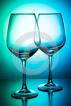 Empty two wine glasses on a green-blue background