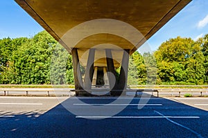 Empty uk motorway under bridge on sunny day in england uk