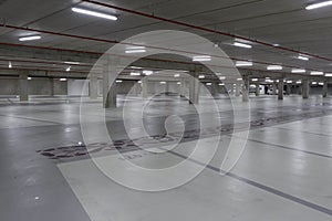 Empty underground car park illuminated at night