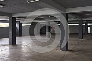 Empty underground parking lot or garage interior with concrete columns