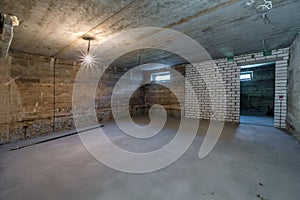 Empty unfurnished basement room with minimal preparatory repairs. interior with white brick walls