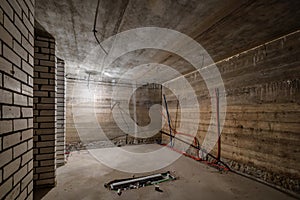 Empty unfurnished basement room with minimal preparatory repairs. interior with white brick walls