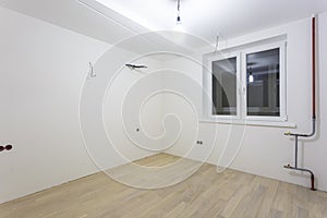 Empty unfurnished room with minimal preparatory repairs. interior with white walls