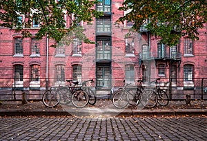 Empty urban street with warehouse brick wall in the back