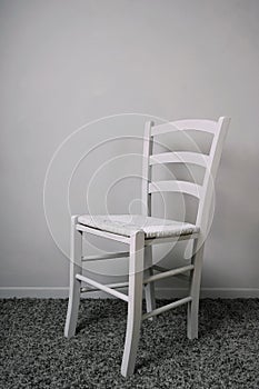 Empty vacant chair in gray room