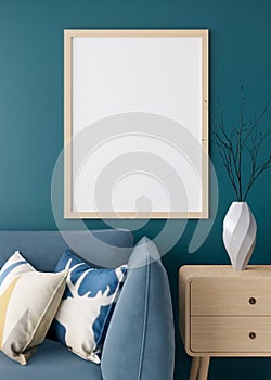 Empty vertical picture frame on blue wall in modern living room. Mock up interior in minimalist style. Free space for