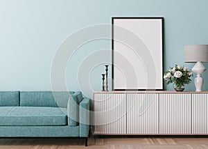 Empty vertical picture frame on light blue wall in modern living room. Mock up interior in contemporary style. Free