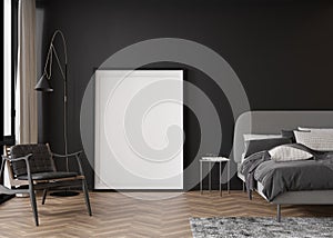 Empty vertical picture frame standing on parquet floor in modern bedroom. Mock up interior in contemporary style. Free