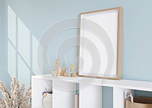 Empty vertical picture frame standing on sideboard in modern child room. Frame mock up in contemporary style. Free, copy