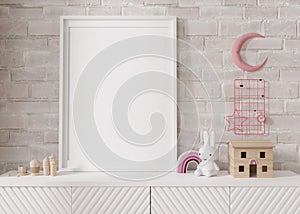 Empty vertical picture frame standing on white sideboard in modern child room. Mock up interior in scandinavian style