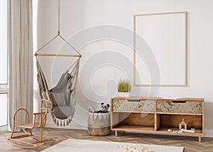 Empty vertical picture frame on white wall in modern child room. Mock up interior in scandinavian, boho style. Free