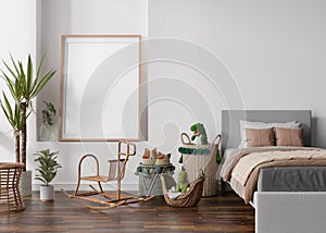 Empty vertical picture frame on white wall in modern child room. Mock up interior in scandinavian, boho style. Free