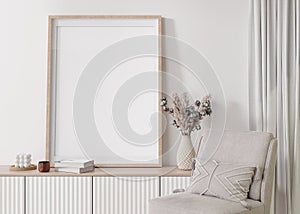 Empty vertical picture frame on white wall in modern living room. Mock up interior in contemporary, scandinavian style