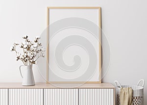 Empty vertical picture frame on white wall in modern living room. Mock up interior in minimalist, scandinavian style