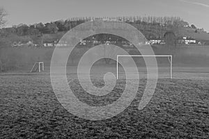 Empty village football field, small amount of fog drifting through