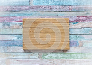 Empty vintage cutting board on planks food background concept