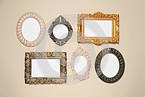 Empty vintage frames hanging on beige wall