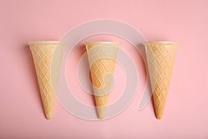 Empty wafer ice cream cones on pink background