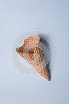 The empty waffle cone on a blue background