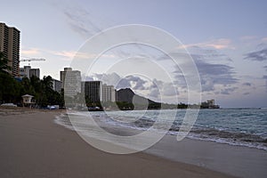 Empty Waikiki Beach on the island of Oahu, Hawaii at Sunrise.