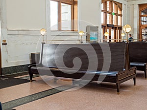 Empty waiting bench at train station terminal awaiting departure train