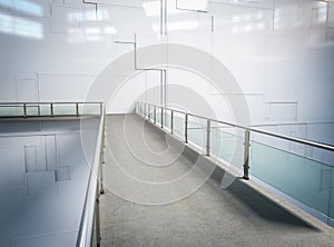Empty walkway with glass barrier