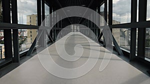 empty walkway, glass pathway, skybridge features.