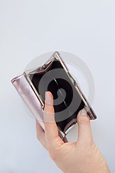 Empty wallet in a woman`s hand. Financial crisis concept. Unemployment, impoverishment, redundancies in enterprises photo