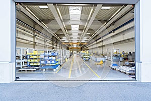 Empty warehouse interior with shelves, pallets , boxes and equipment.