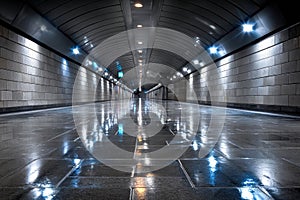 Empty wet underground passage at night