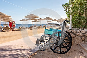 Empty wheelchair against the background of tropical beach