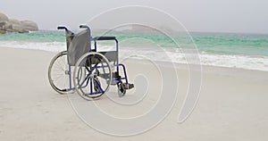 Empty wheelchair at beach on a sunny day 4k